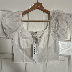 White- Size: Medium 
White bustier top
Hook and eye closures
Corset style